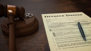 Image of a divorce decree with a gavel set next to it.