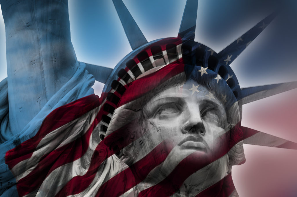 The Statue of Liberty with the American flag superimposed onto it in patriotic concept